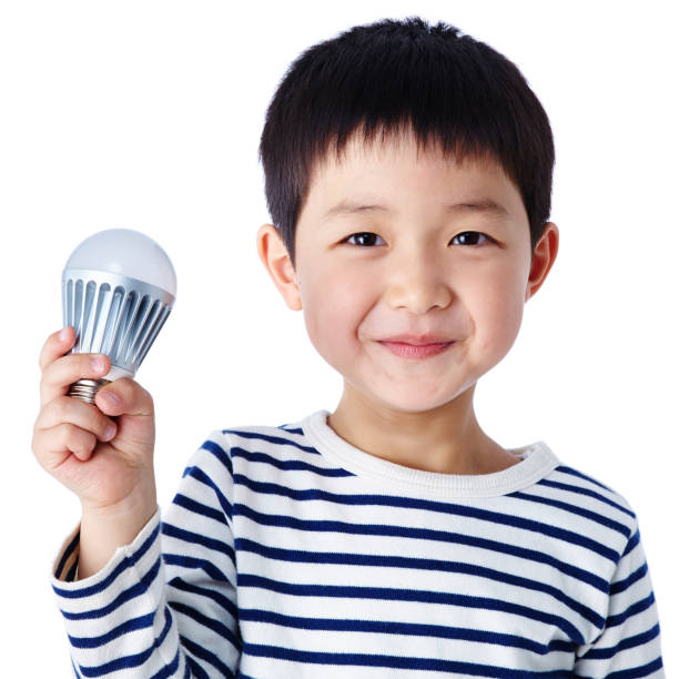 Little boy with LED light bulb stock photo