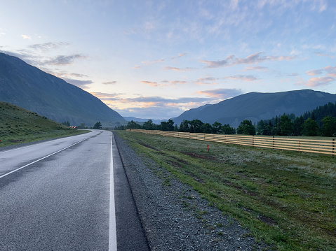 Road in the mountains at sunset. Russia, Siberia, Altai mountains.