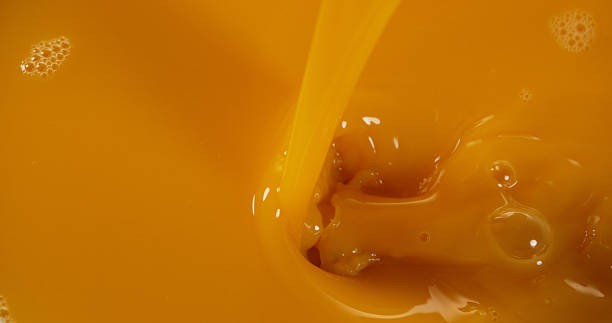 istock Orange Juice being poured 1688256937