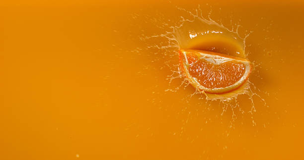 istock Orange, citrus sinensis, Fruit falling into Orange Juice 1688257513