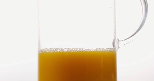 istock Orange Juice being poured into Glass against White Background 1688258587