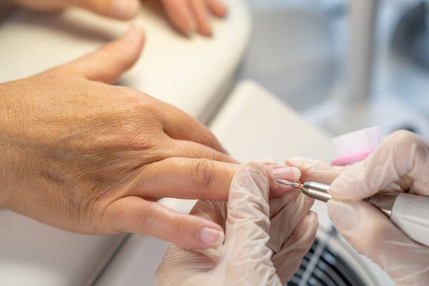 istock Female hands and tools for manicure, process of performing manicure 1688259230