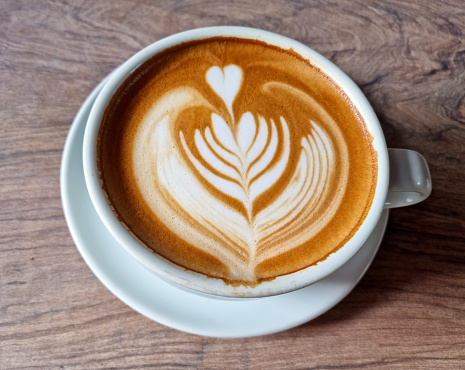 Art coffee latte on wooden background