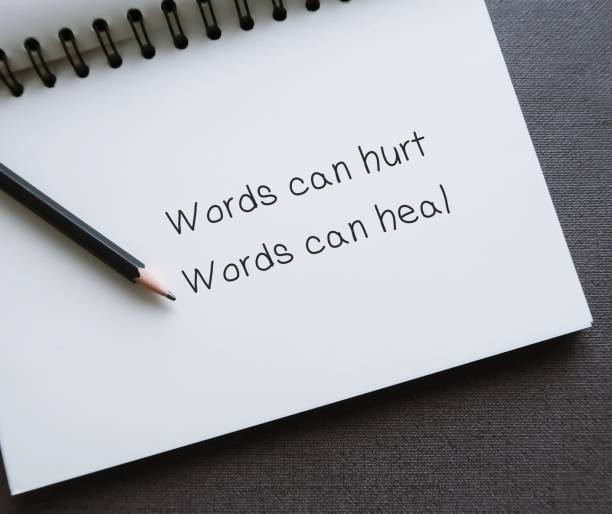 istock Notebook with handwritten text Words can hurt Words can heal - to remind language have power to harm or heal - word choice matters most so choose wisely 1688263469