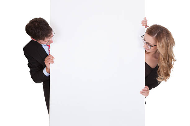 istock Professional man and woman with a blank sign 168826428