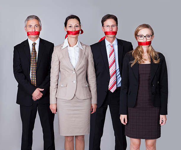 istock Businesspeople bound by red tape 168826521