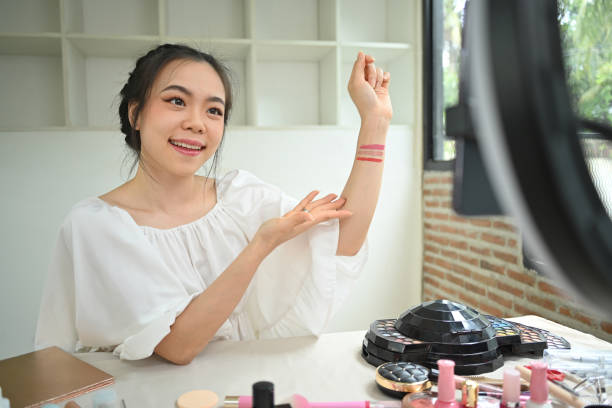 istock Confident female blogger testing new lipstick different color on her hand recording make up tutorial at home 1688275290