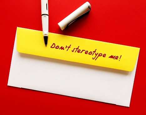 Yellow office envelope with handwritten message - Don't stereotype me! -  to stop stereotypes or generalization about how a group of people behaves, unfair and untrue belief about others