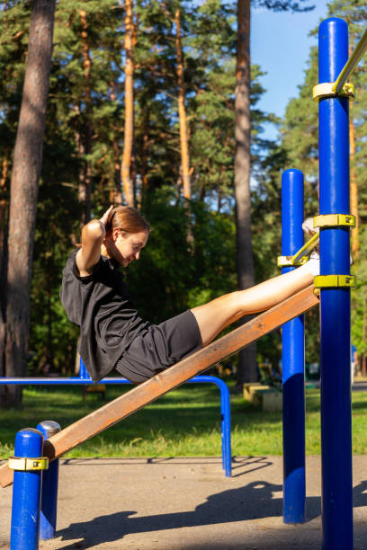 istock A teenage girl doing abdominal crunches. 1688288037