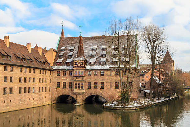 Nuremberg at Christmas time, ancient medieval hospital along the river,  Germany
