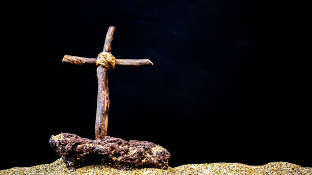 istock wooden cross on black background 1688296901