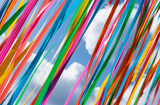 Germany, Berlin, July 04, 2023 - Colorful ribbons in the wind against sky Berlin Tiergarten