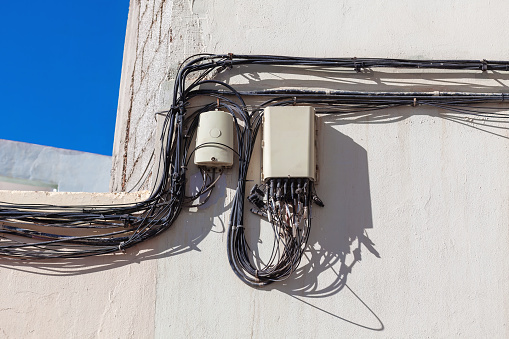 ables and wires on the wall of a building