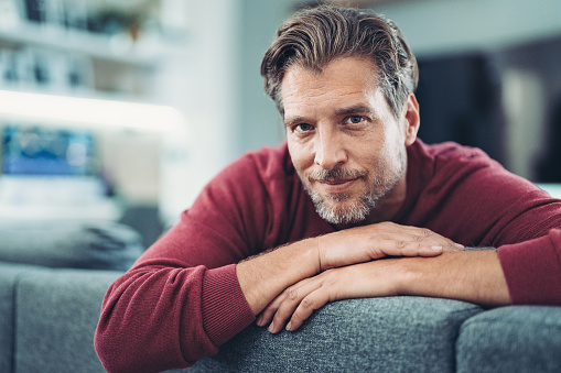 Middle aged man enjoying relaxing time at home