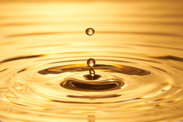 istock Group of water droplets fall and bounce on a water surface 1688314490