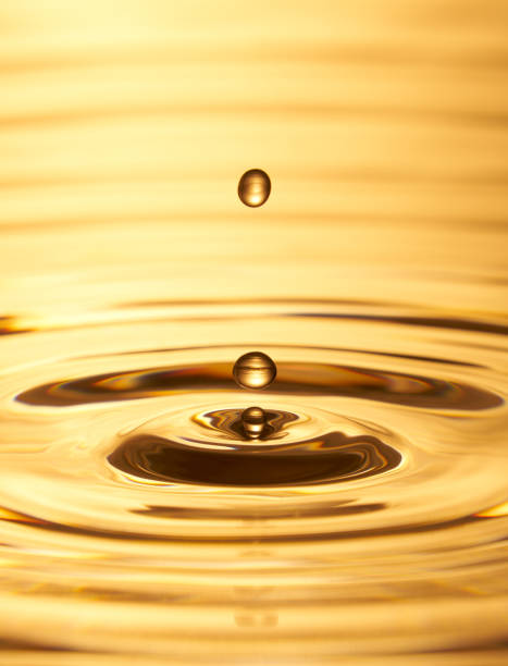 istock Group of water droplets fall and bounce on a water surface 1688314501