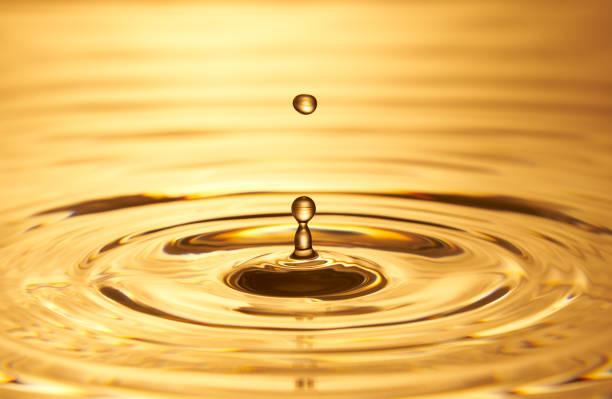 istock Group of water droplets fall and bounce on a water surface 1688314526