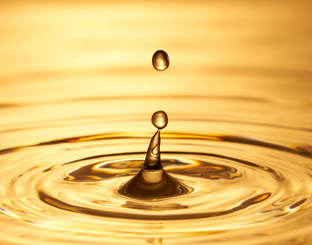 istock Group of water droplets fall and bounce on a water surface 1688314531
