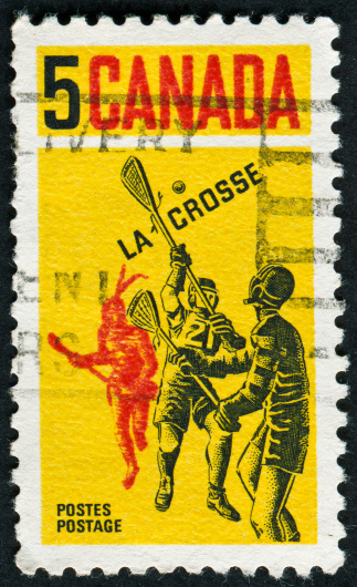Cancelled Stamp From Canada Showing The Sport Of Lacrosse Which Was Invented By Native Americans As Can Be Seen By The Red Figure In The Background