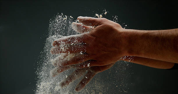 istock Hands of Man with Flour against black background 1688323669