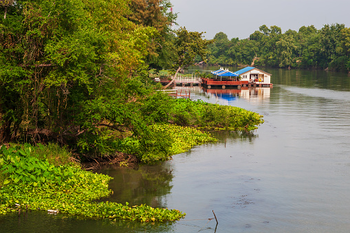 River Kwai (Khwae Yai) with floating restaurant in Kanchanaburi, Thailand.