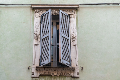 Detail of a window decorated with a bas-relief in Art Nouveau style, popular between 1890 and 1910 during the Belle Époque period, Parma, Emilia-Romagna, Italy