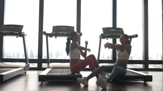 Women work out at fitness club.