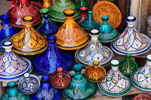 Colorful Moroccan cooking pots at a souk in Marrakech. A tajine is a Maroccan dish from that is named after the special earthenware pot in which it is cooked.