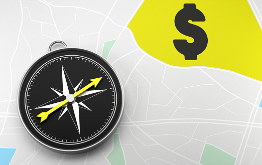 The compass on the map indicates Dollar Sign. Advice Concept.