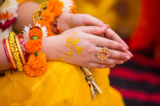 Closeup of Indian woman hands wearing golden ring praying and celebrating doing namaste, Girl prayer hands folded, indian wedding haldi ceremony - Image
