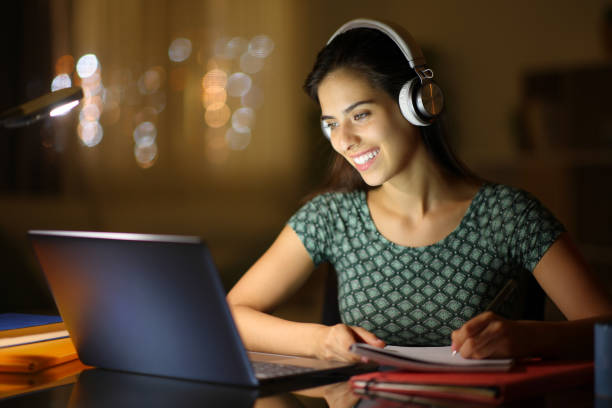 istock Happy student in the night elearning at home 1688359259