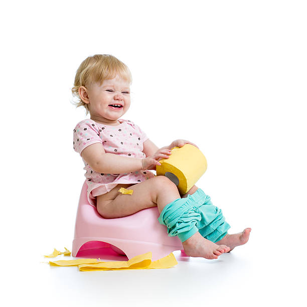 smiling baby sitting on chamber pot with toilet paper roll smiling baby sitting on chamber pot with toilet paper roll accustom stock pictures, royalty-free photos & images
