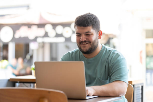 istock Plus sized young man is working on the outside. 1688402166