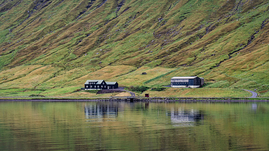 Faroe Islands Kaldbaksfjørður Fjord Reflections. Rural Houses at the waterfront of Streymoy Island Fjord close to Kaldbaksbotnur - Kaldbak, Kaldbaksfjørður Fjord, Streymoy Island, Färör Islands, Kingdom of Denmark, Nordic Countries of Northern Europe.