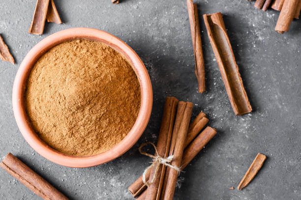 istock Cinnamon sticks and cinnamon powder on rustic background, healthy spice, (Cinnamomum) 1688414624