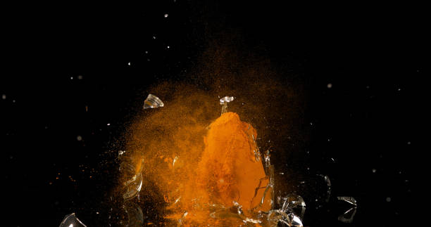 istock Turmeric, curcuma longa, Powder in a Small Jar Exploding against Black Background, Indian Spice 1688418238
