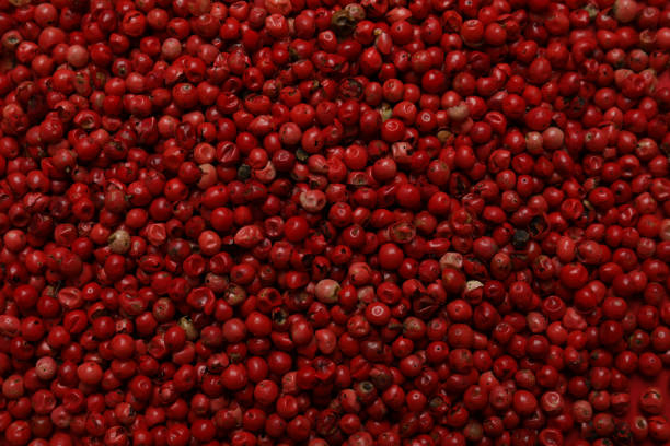 istock Red peppercorns on whole background, close up 1688419370