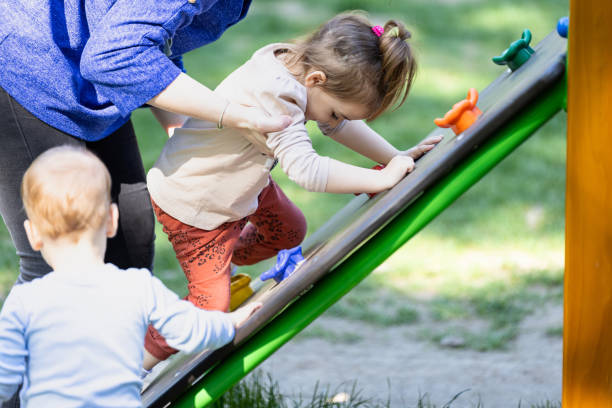istock Kid learning how to climb in outdoor playground. 1688420285