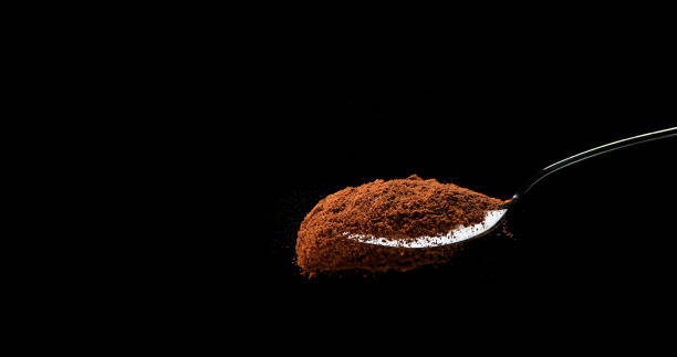 istock Nutmeg, myristica fragans, Powder falling from Spoon against Black Background 1688438659