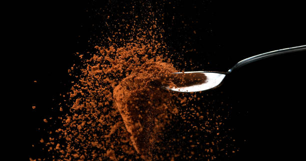 istock Nutmeg, myristica fragans, Powder falling from Spoon against Black Background 1688440842