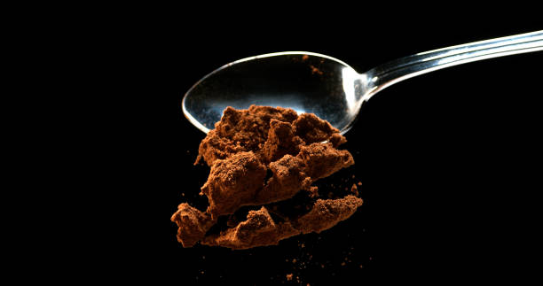 istock Nutmeg, myristica fragans, Powder falling from Spoon against Black Background 1688440859