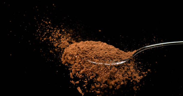 istock Nutmeg, myristica fragans, Powder falling from Spoon against Black Background 1688441385