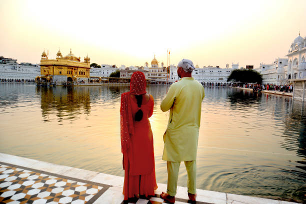 istock Young couple visit at Golden temple, India 1688462344
