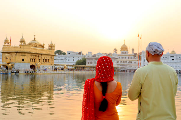 Young couple visit at Golden temple, India stock photo