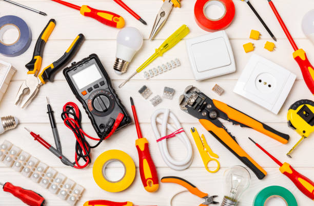 istock Electrician tools on  background.Multimeter,construction tape,electrical tape, screwdrivers,pliers,an automatic insulation stripper, socket and LED lamp.Flatley.electrician concept. 1688463019
