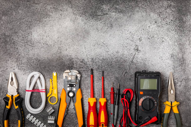 istock Electrician tools on  background.Multimeter,construction tape,electrical tape, screwdrivers,pliers,an automatic insulation stripper, socket and LED lamp.Flatley.electrician concept. 1688463023