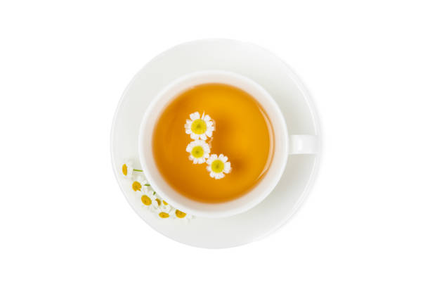 Chamomile herbal tea with flower buds and chamomile bouquet isolated on white background. Useful herbal, soothing drinks and natural healer concept. Immunity tea.Close up. Copy space.