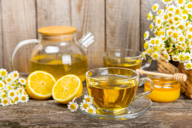 istock Chamomile tea in a  cup on a  texture background. Natural hour with chamomile flowers. Herbal tea. Immunity tea.Natural healer concept. Healthy detox drink.Close up. Place for text. 1688463288