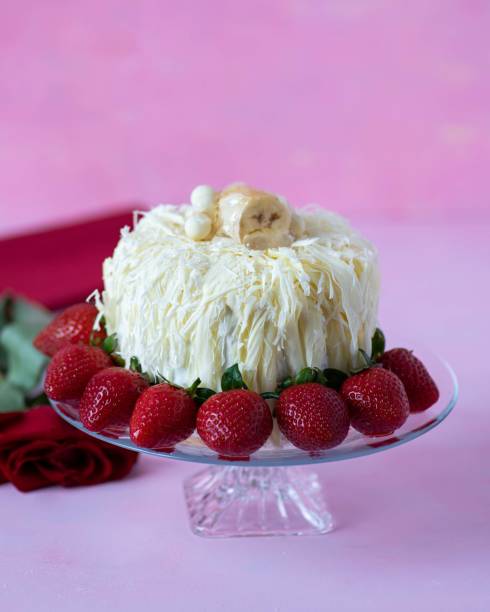 istock Chocolate cake with strawberry cream on pink background 1688463744