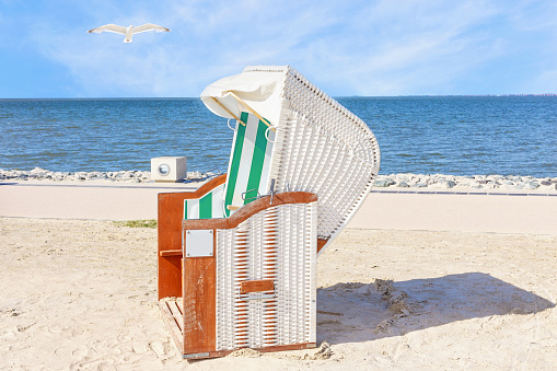 Rearview shot of a senior couple relaxing in beach chairs while looking at the view over the water